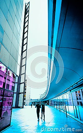 Modern archtecture and two unrecognizable peole in the way Editorial Stock Photo