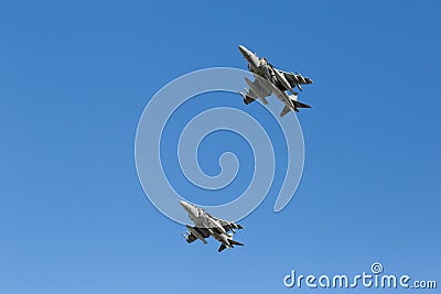 Modern armed military fighter jets flys in formation through the sky Stock Photo