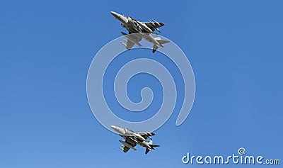 Modern armed military fighter jets flys in formation through the sky Stock Photo