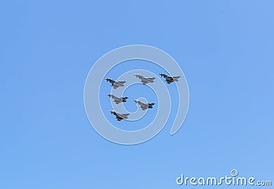 Modern armed military fighter jets flys in formation through the sky Stock Photo