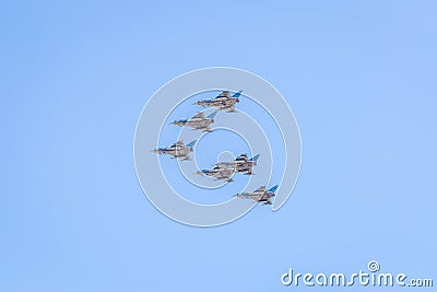 Modern armed military fighter jets flys in formation through the sky Stock Photo