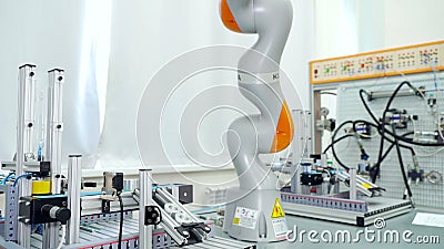 Modern automated hand in enterprise. Scene. Automated robot arm for rearranging finished parts in modern factory. Modern Stock Photo