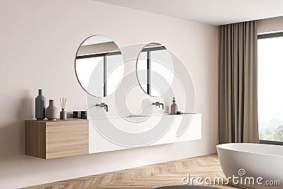 Modern bathroom vanity with two round mirrors on beige wall. Corner view Stock Photo