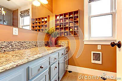 Modern bathroom with wooden shelves and rustic iron faucet Stock Photo