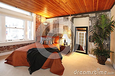 Modern bedroom with a broken concrete wall Stock Photo