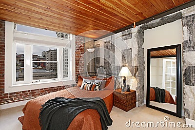 Modern bedroom with a broken concrete wall Stock Photo