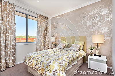 Modern bedroom with a master bed and light brown color curtain d Stock Photo