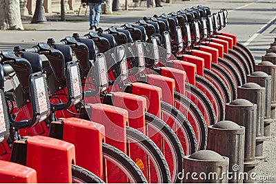 Modern bikes to rent in a Barcelona bike station in Spain in a sunny day Editorial Stock Photo