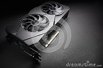 Modern black computer video card on a black background, deep shadows and contrasting light, one object close view, electronic Stock Photo