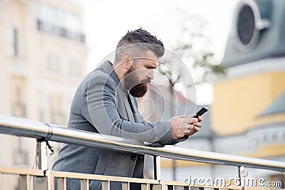 Modern blogger with hipster beard blog post from mobile phone urban outdoors, blogging Stock Photo