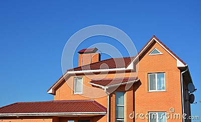 Modern Brick House Facade Exterior. Modern House Construction. Hip and Valley roofing types. Stock Photo