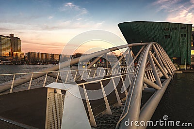Modern bridge over the Oosterdok canal leading to Nemo Science Museum Editorial Stock Photo
