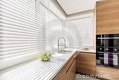 Kitchen with white window blinds Stock Photo