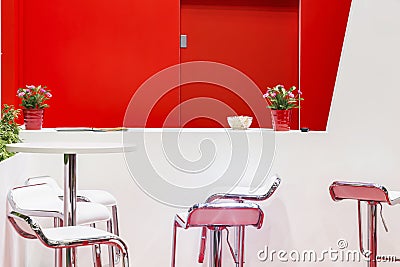 Modern bright red and white room interior with table chairs armchairs Stock Photo