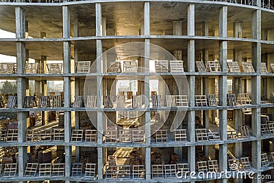 Modern building under construction detail, concrete frame, window openings and scaffolding background Stock Photo