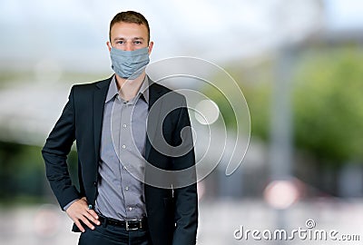 Modern businessman with face mask outdoor in city Stock Photo
