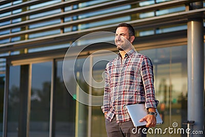 Modern businessman standing outside office Stock Photo