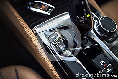 Car Interior: Details of Modern Center Console with Dials, Buttons and Gear knob Stock Photo