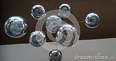 Modern chandelier background, round lamps over ceiling Stock Photo