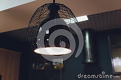 modern chandelier with seven round plafonds with lamps inside them against black background. electric fixture with round Stock Photo