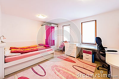 Modern children girl play room with bed and study desk. Stock Photo