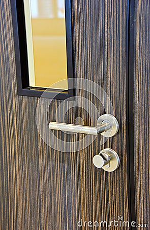 Modern chrome door handle on door Stock Photo