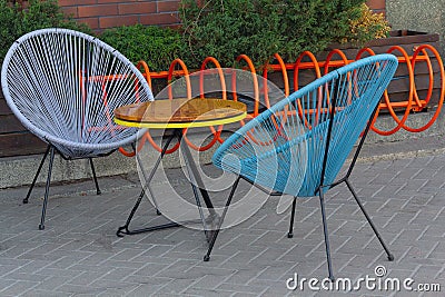 Modern colored furniture of a street cafe Stock Photo