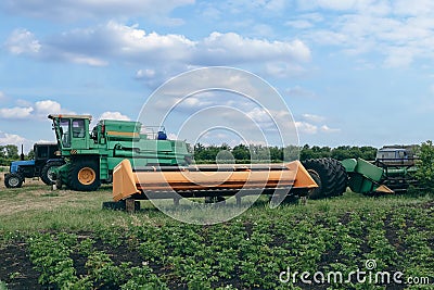 Modern combine harvester, tractor and plough in agricultural field Editorial Stock Photo