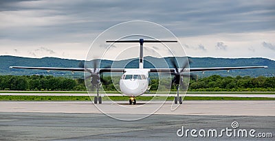 Modern commercial passenger plane with turbine engine on airfield. Journey and vacation concept. Aviation and transportation Stock Photo