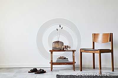Modern composition of stylish living room interior with creative vintage chair, small side table and elegant personal accessories. Stock Photo