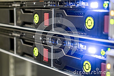 Modern computer equipment is installed in the server room. Many hard drives are in a powerful router on the hosting site. The Stock Photo