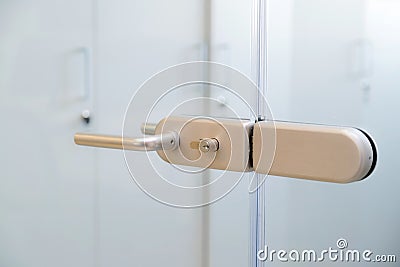 Modern, contemporary glass door lock handle in modern business office Stock Photo