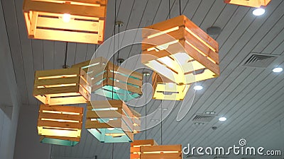 Modern creative ceiling chandeliers in the interior of wooden drawers with light bulbs inside. Stock Photo