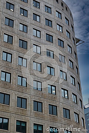 Modern curved office building facade against a clear blue sky in Leeds, UK Stock Photo