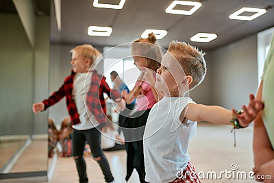 Modern dancers. Group of fashionable children learning a modern dance while having a choreography class. Dance studio Stock Photo
