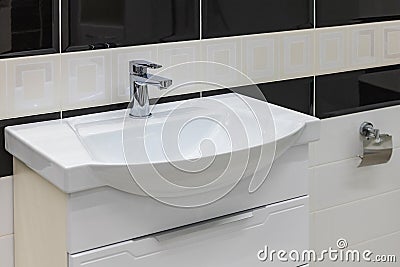 Modern design bathroom sink in a modern residential building or hotel. Modern white bathroom sink with a tap. Selective focus Stock Photo