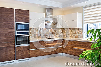 Modern design of the kitchen in a light, bright interior. Stock Photo