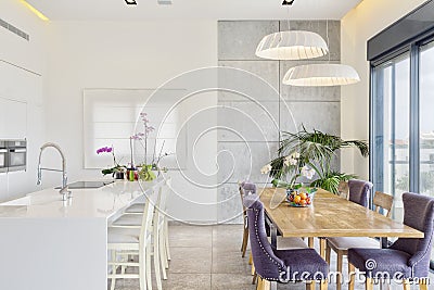 Modern Design Of Luxury White Kitchen With Marble Island And Dinner Table Stock Photo