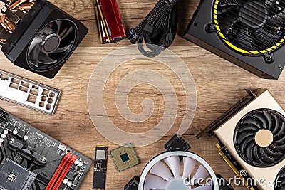 Modern desktop computer hardware components on wood desk table background. Circle shaped of pc parts like cpu fan cooler Stock Photo