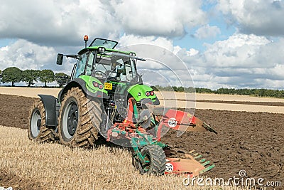 Modern deutz fahr tractor pulling a plough Editorial Stock Photo