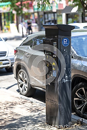 Modern Digital Parking Meter Station on a Busy City Street During Daytime Editorial Stock Photo