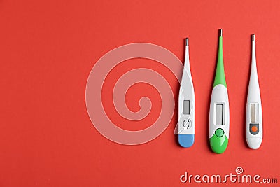 Modern digital thermometers on background, flat lay. Space for text Stock Photo