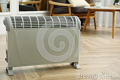 Modern electric convection heater on floor at home Stock Photo