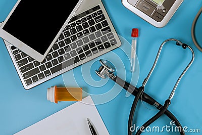 Modern electric tonometer and a stethoscope on a computer keyboard blood pressure monitor Stock Photo