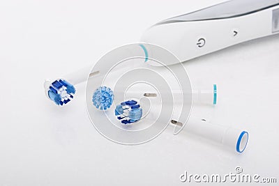 Modern Electric Toothbrush with a Few Spare Heads Together Stock Photo