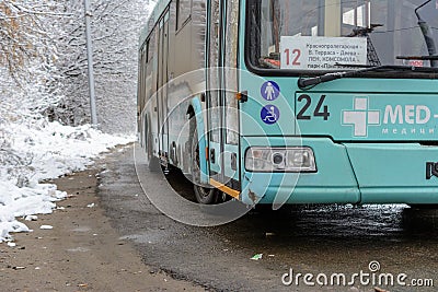 Modern electric trolley bus departing from public transport stop in the winter sunny day. Environmentally friendly transport Editorial Stock Photo