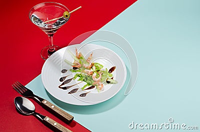 Modern elegant geometric style in food - appetizer of shrimps, greens, celery, teriyaki sauce with martini cocktail with shadow. Stock Photo