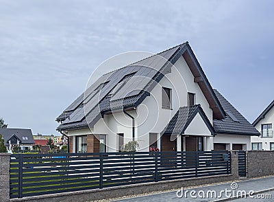 Modern elegant private house in Poland with solar panels and elegant metal fence Editorial Stock Photo