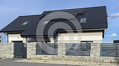 Modern elegant private house in Poland with solar panels and elegant metal fence Stock Photo