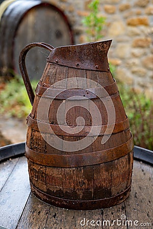 Equipment for producing of red, rose and white wine on South of France in Provence. Wooden grape juice jug Stock Photo